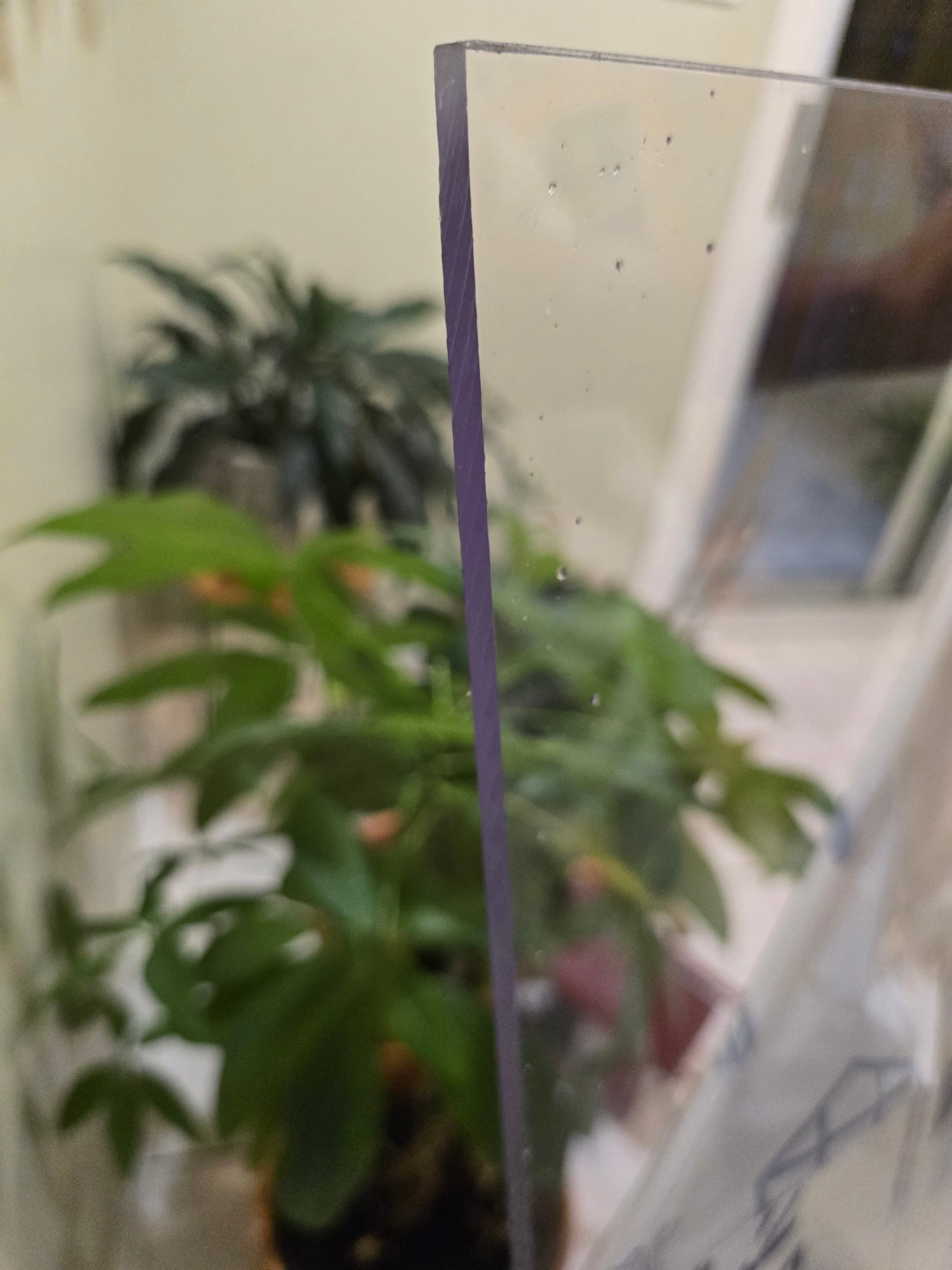 Close-up of polycarbonate sheet edge showing thickness and clarity for security applications