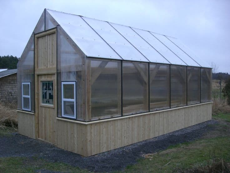 Wood-framed greenhouse with a twinwall polycarbonate roof and walls