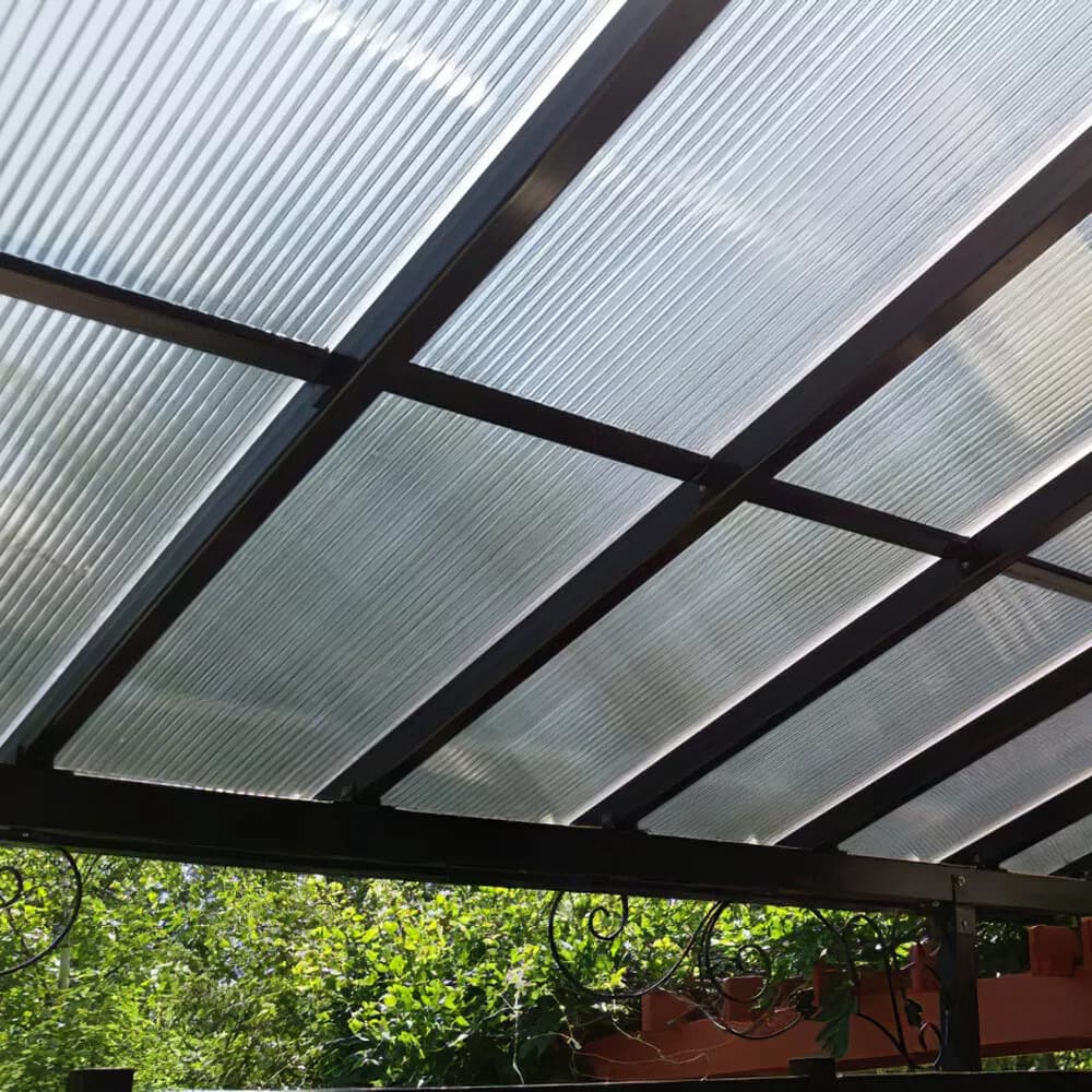 Underside of a twinwall polycarbonate patio roof on a black aluminum frame